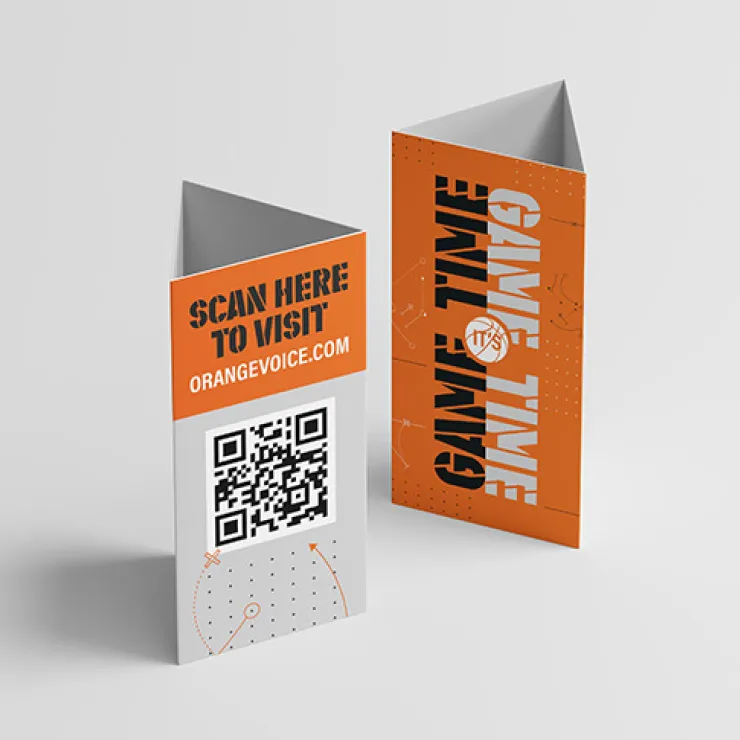 Two folded promotional cards are displayed. The front card features a QR code with the text "SCAN HERE TO VISIT ORANGEVOICE.COM" above it. The back card is orange with the words "GAME TIME" written vertically and various graphic elements surrounding the text.