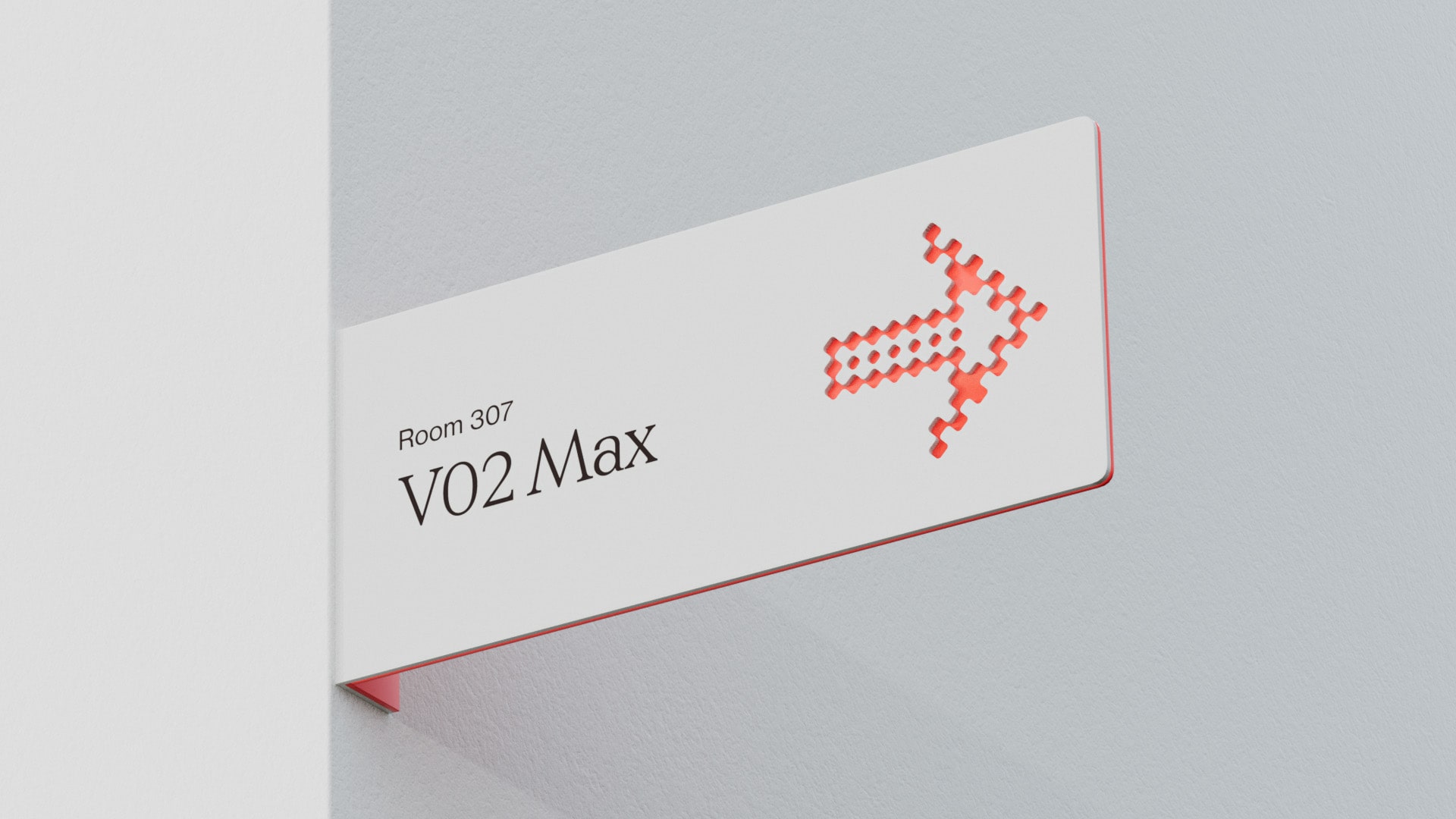 A wall-mounted sign points to the right with a red, pixelated arrow. The sign reads "Room 307 V02 Max" in bold black lettering on a white background. The edges of the sign are accented with a thin red border. The wall is painted a light gray color.