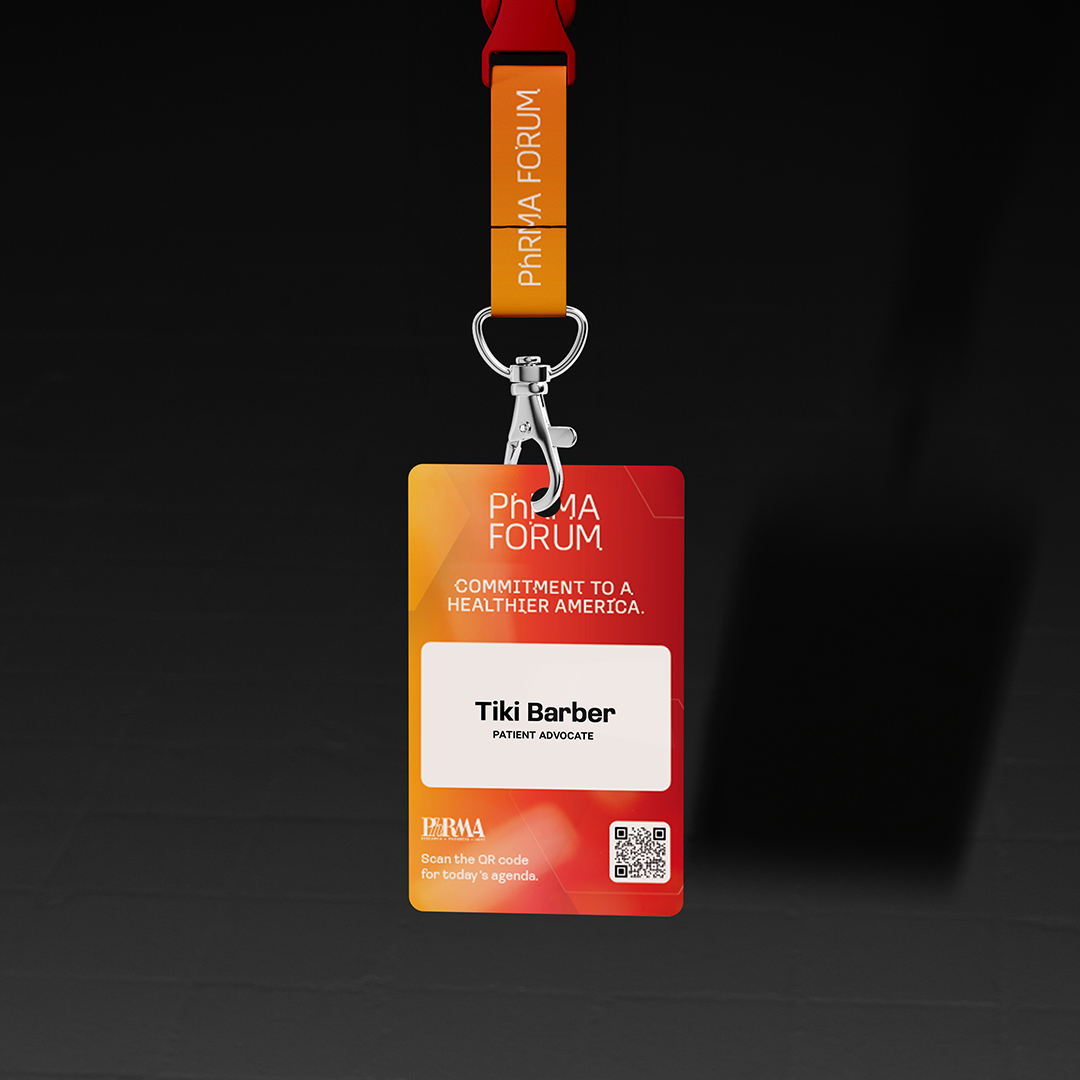 A conference badge on a red and orange lanyard features "PRMA FORUM, COMMITMENT TO A HEALTHIER AMERICA." It displays "Tiki Barber," title "PATIENT ADVOCATE," and a QR code. Focusing on public policy communications, this event underscores a strategic commitment to healthcare advancement.